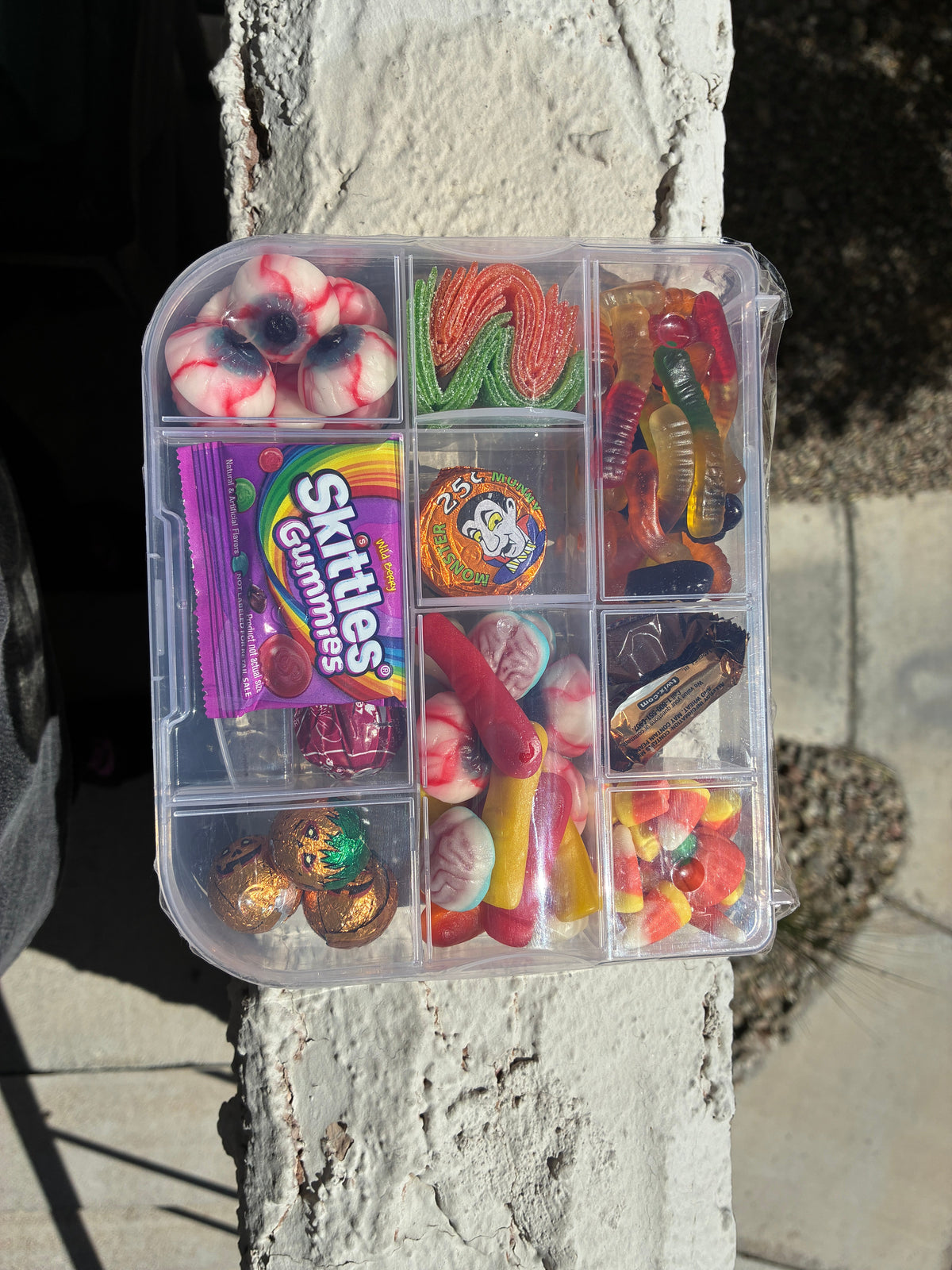 Side view of Halloween candy bento box with assorted spooky candies